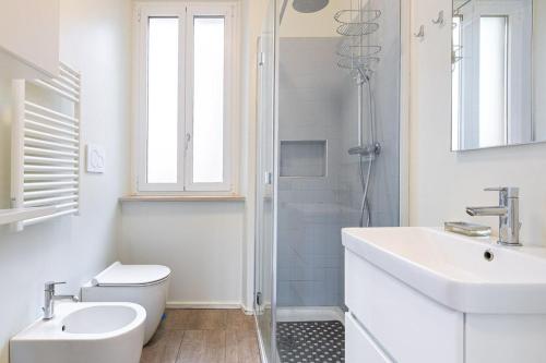a bathroom with a toilet and a sink and a shower at Casa Pertinace in Alba