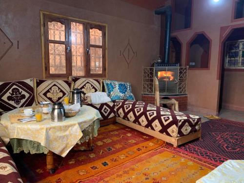 a living room with a couch and a table at Auberge Des Jardins du Dades in Boumalne