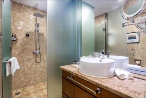 a bathroom with a sink and a shower at Atour Hotel Beijing West Railway Station South Square in Beijing