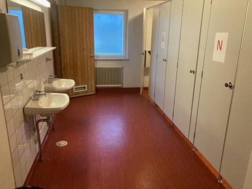 a bathroom with two sinks and two toilets at Stadium Apartments in Tornio