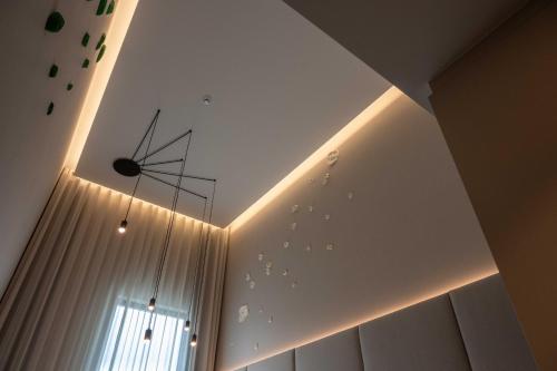 a room with a ceiling with a clock and a window at Dolinas Climbing Hotel in Porto de Mós