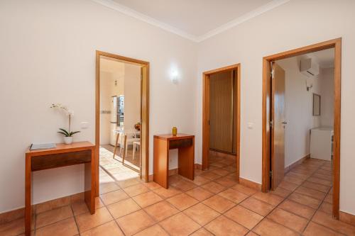 a room with a hallway with a table and a mirror at Host Wise - Bright & Stylish Lagos Flat with Pool in Lagos