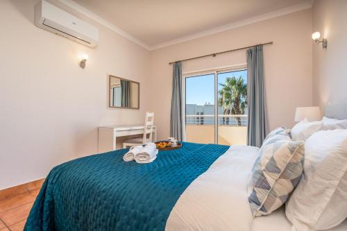 a bedroom with a bed with a view of the ocean at Host Wise - Bright & Stylish Lagos Flat with Pool in Lagos