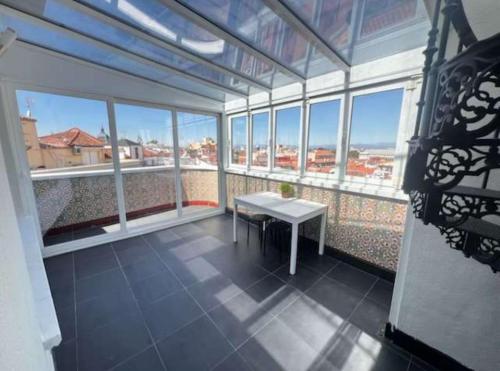 a large room with a table in a room with windows at Alhambra Suites in Madrid