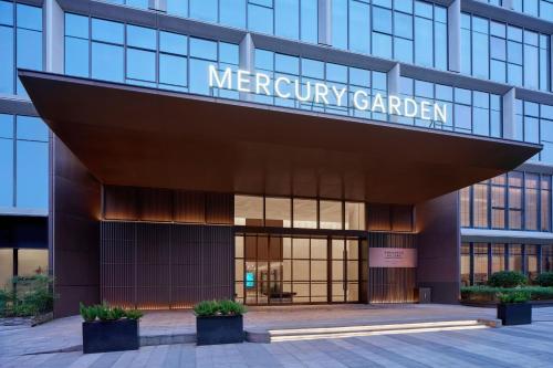 a building with a sign that reads mercury garden at The Mercury Garden Shenzhen Nanshan, A Tribute Portfolio Hotel in Shenzhen
