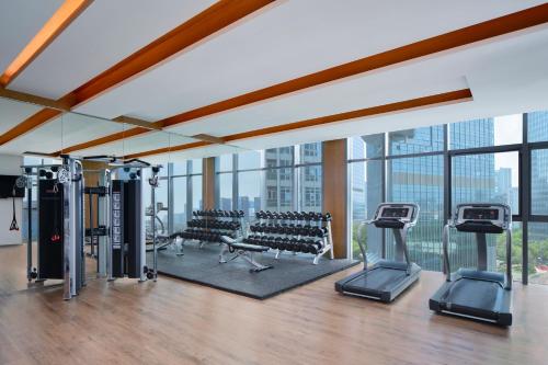 a gym with treadmills and exercise equipment in a building at The Mercury Garden Shenzhen Nanshan, A Tribute Portfolio Hotel in Shenzhen