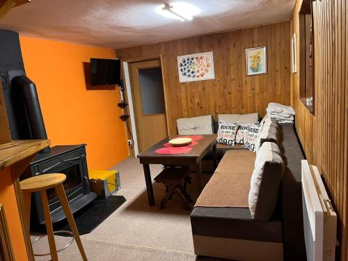 a living room with a couch and a table at Vikendica Šipovac in Jahorina