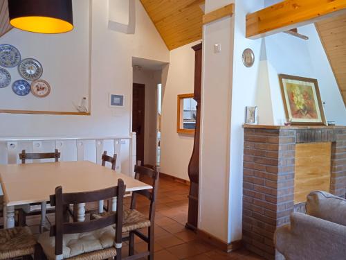 a dining room with a table and chairs and a fireplace at Apartamentos 3000 Escarrilla in Escarrilla