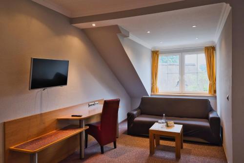 a living room with a couch and a table at Egestorfer Hof in Egestorf