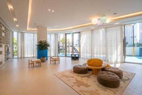 a lobby with tables and chairs and large windows at GuestReady - Elegant 1BR l Premium Amenities in Dubai