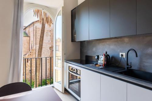 a kitchen with a sink and a window with a view at JOIVY Cavour 238 in Rome