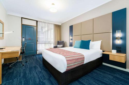 a hotel room with a bed and a desk at Quality Hotel Parklake Shepparton in Shepparton