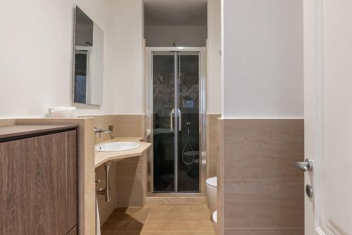 a bathroom with a toilet and a sink and a shower at JOIVY Cavour 238 in Rome