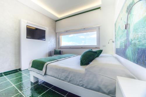 a bedroom with a large bed and a window at La Madegra Seasuite in Salerno