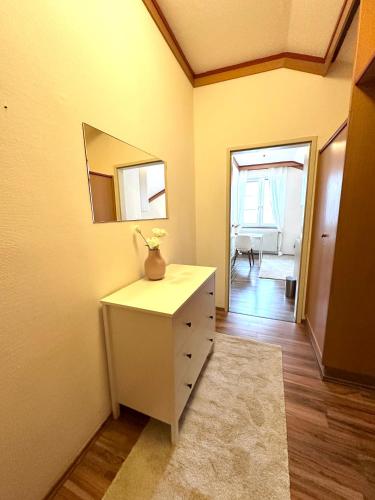 a room with a white dresser and a mirror at Hochkogelhaus - flying oasis, Hohe Wand in Maiersdorf
