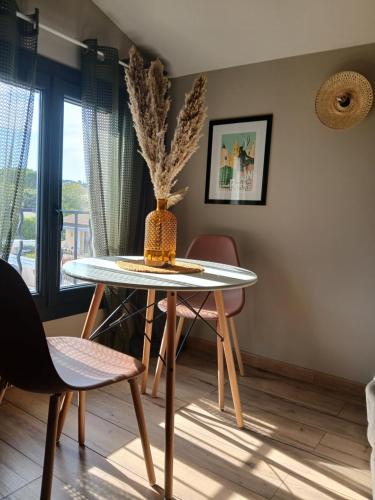a table with a vase on it in a room at chambres dans les Alpilles les jardins de meyrol in Eyguières