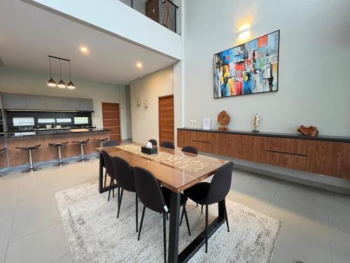 a dining room with a table and chairs at Royal Hill Villa Cisarua Puncak in Puncak