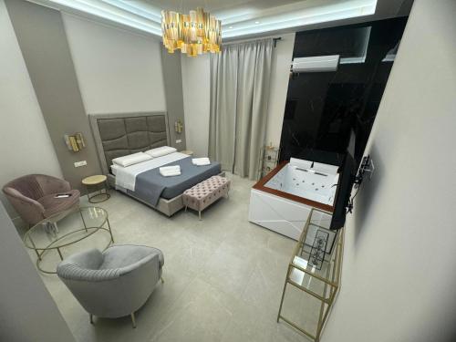 a view of a bedroom with a bed and a chair at InCentro Elegant Rooms in Messina