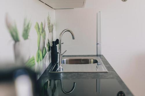a kitchen counter with a sink in a kitchen at Apartman Zvjezdana in Krk