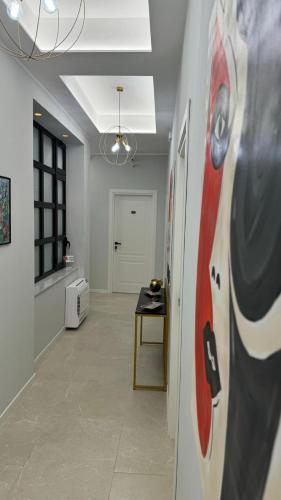 a hallway with a table and a painting on the wall at InCentro Elegant Rooms in Messina