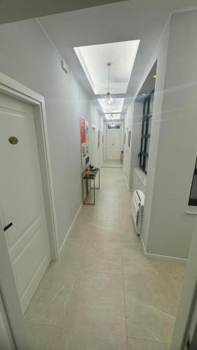 a hallway with white walls and a white door at InCentro Elegant Rooms in Messina