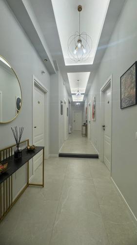 a hallway with white walls and a ceiling with a mirror at InCentro Elegant Rooms in Messina