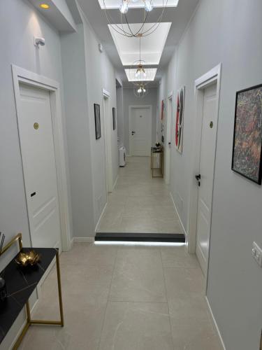 a hallway with white walls and a tile floor at InCentro Elegant Rooms in Messina