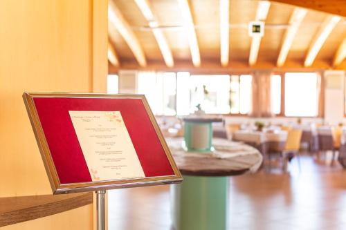 a menu sign in a restaurant with a table at Marc Hotel in Vieste
