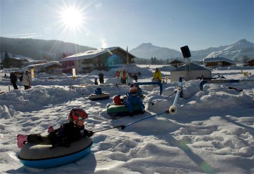 a group of people on snowboards in the snow at Ferienwohnung Biechl-Hauser Doris in Sankt Ulrich am Pillersee