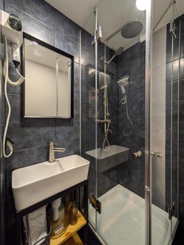 a bathroom with a sink and a shower at Солодка Мить in Slavske