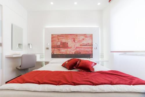 a bedroom with a large bed with a red blanket at La Madegra Seasuite in Salerno