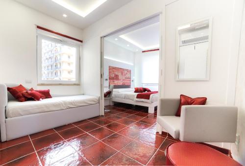a living room with two beds and a mirror at La Madegra Seasuite in Salerno