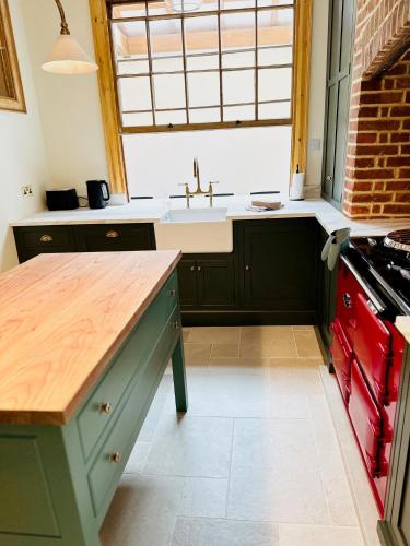 a kitchen with a sink and a counter top at Oxford Grade II listed house in Woodstock