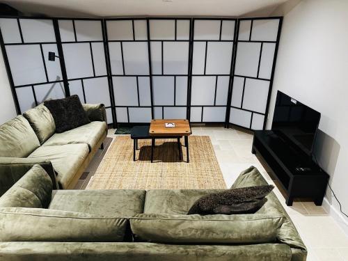 a living room with a couch and a table at Oxford Grade II listed house in Woodstock