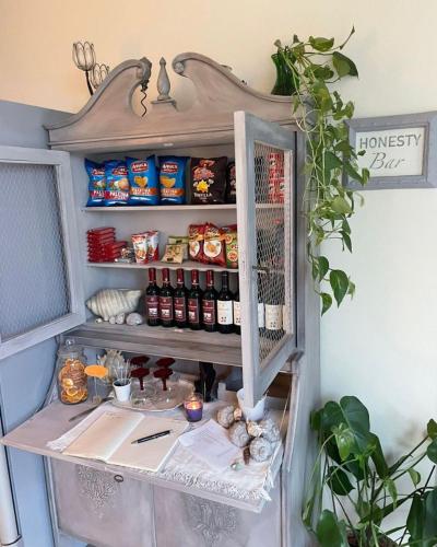 a shelf in a kitchen with food and drinks at Hotel Loretta & Dependance in Cervia