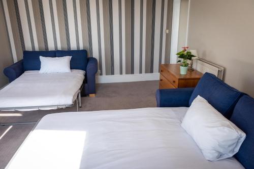 a hotel room with a bed and a couch at Queens Hotel & Spa in Brighton & Hove