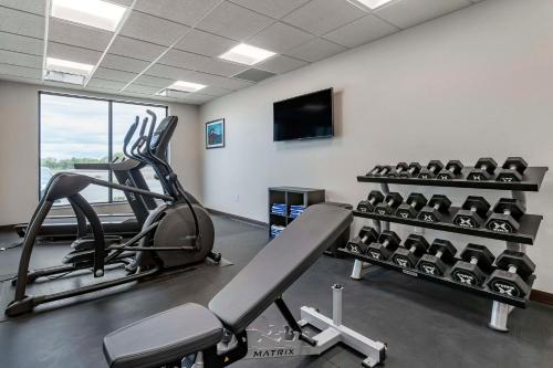 a gym with tread machines and a flat screen tv at MainStay Suites Milwaukee-Franklin in Franklin