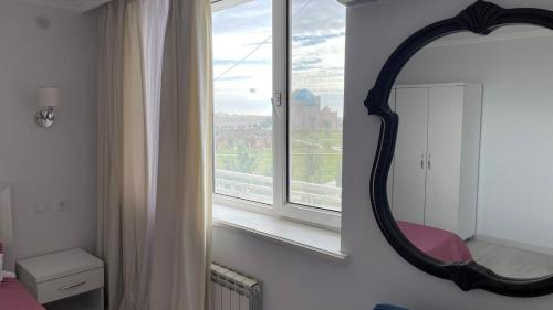 a bathroom with a mirror and a window at Yassy hotel, Turkistan in Türkistan