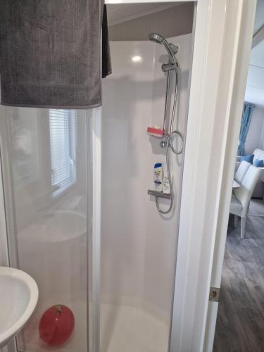a shower stall in a bathroom with a sink at Cresswell Towers in Morpeth