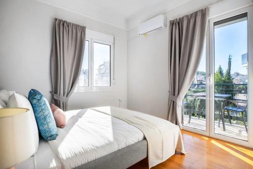 a bedroom with a bed and a large window at Modern Apt opposite the Acropolis Museum in Athens
