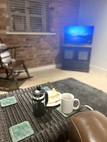 a table with two coffee cups and a plate of food at Grand Mill: Near to Shops, Attractions, Restaurant in Burton upon Trent