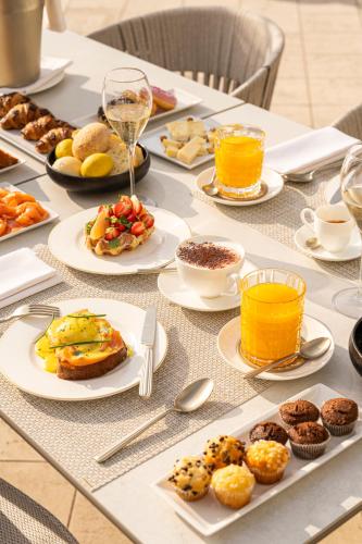 a table topped with plates of breakfast foods and drinks at Bellerive Lifestyle Hotel in Salò