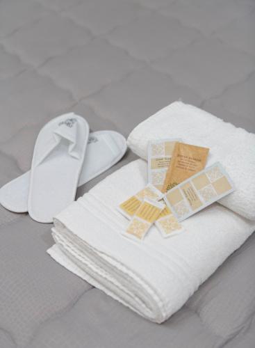 a pile of towels with tags on them on a bed at Villa Teresa Relax in Corbara
