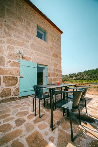 a patio with tables and chairs in front of a building at Casa do Marujo e Casa do Mirone in Fornos de Algodres