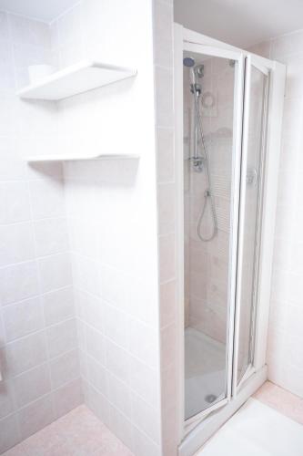 a shower with a glass door in a bathroom at La finestra sulla piazza in Pisticci