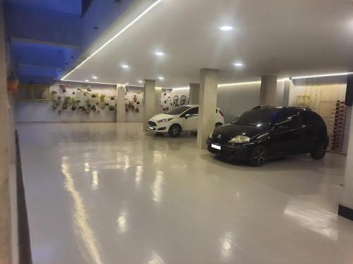 a garage with two cars parked in it at Apart-hotel Theotókos Flats in Piumhi