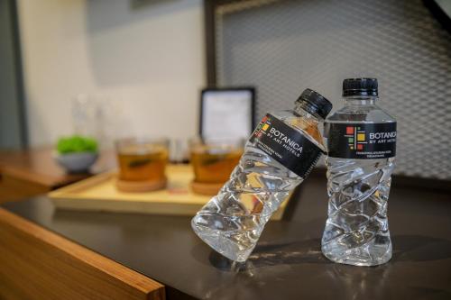 a bottle of water sitting on top of a table at Hotel Botanica in Belgrade