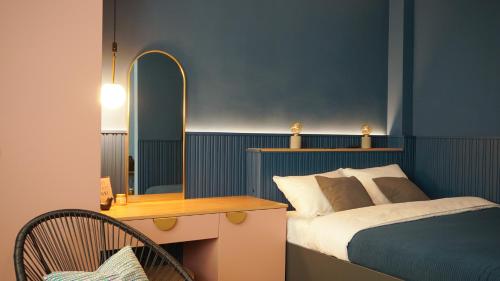 a bedroom with a bed and a desk with a mirror at Aozora Central Studio in Bucharest