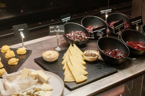 a display of cheese and other foods on a counter at Hotel Toplice - Terme Krka in Smarjeske Toplice
