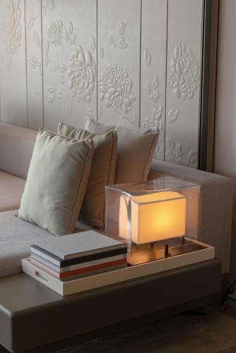 a lamp on a table with books on a couch at Shenzhen Marriott Hotel Nanshan in Shenzhen